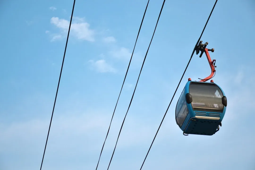 cable car ascending a mountain peak